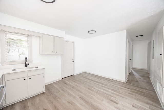 2104 Wellborn Dr, Columbus, GA 31907 - kitchen featuring light wood-type flooring, light countertops, and white cabinetry