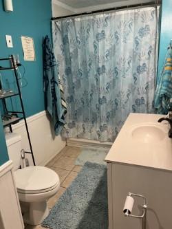 full bathroom featuring tile patterned floors, vanity, toilet, and shower / bath combo with shower curtain