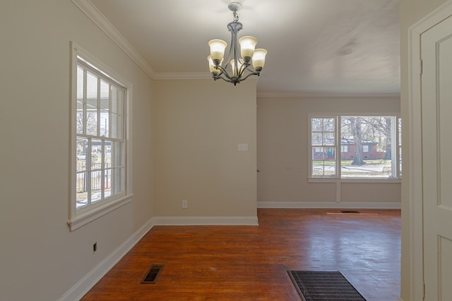 spare room with plenty of natural light, visible vents, and a chandelier