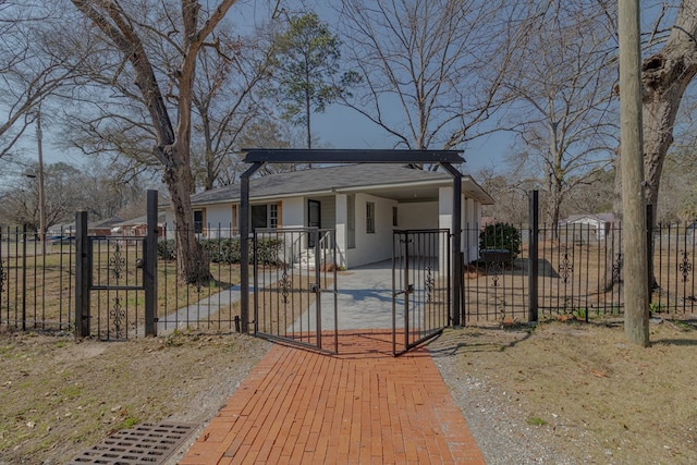 bungalow-style house featuring a gate, an attached carport, stucco siding, and a fenced front yard