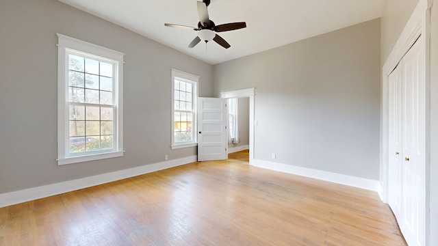 unfurnished bedroom with a closet, light wood finished floors, and baseboards