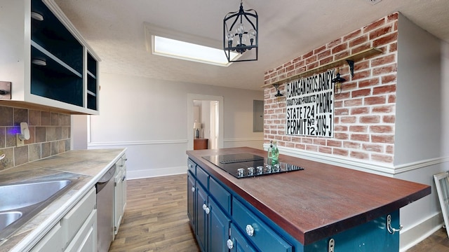 kitchen featuring decorative light fixtures, open shelves, decorative backsplash, blue cabinets, and black electric cooktop