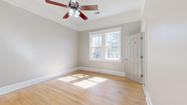 spare room featuring light wood-style floors, baseboards, visible vents, and ceiling fan