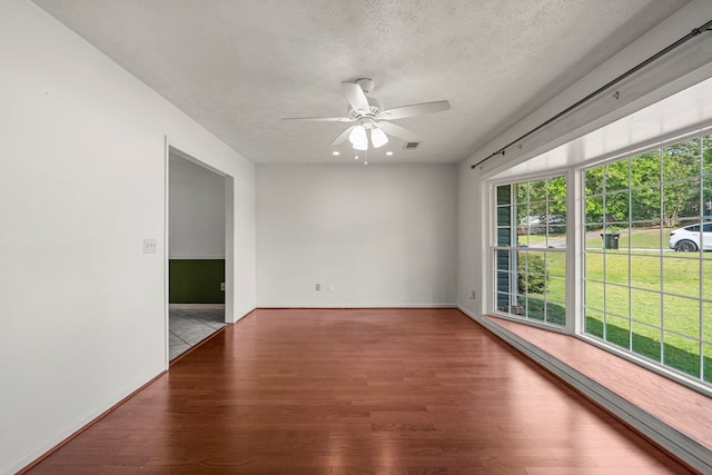 3925 Chris Dr, Columbus, GA 31909 - spare room featuring wood finished floors, a ceiling fan, a textured ceiling, and baseboards