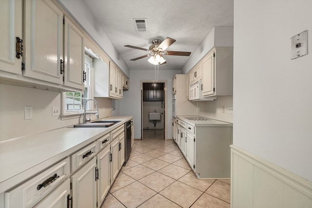 3925 Chris Dr, Columbus, GA 31909 - kitchen featuring a sink, ceiling fan, white appliances, light countertops, and a textured ceiling