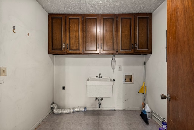 3925 Chris Dr, Columbus, GA 31909 - washroom featuring cabinet space, hookup for a washing machine, hookup for an electric dryer, tile patterned floors, and baseboards