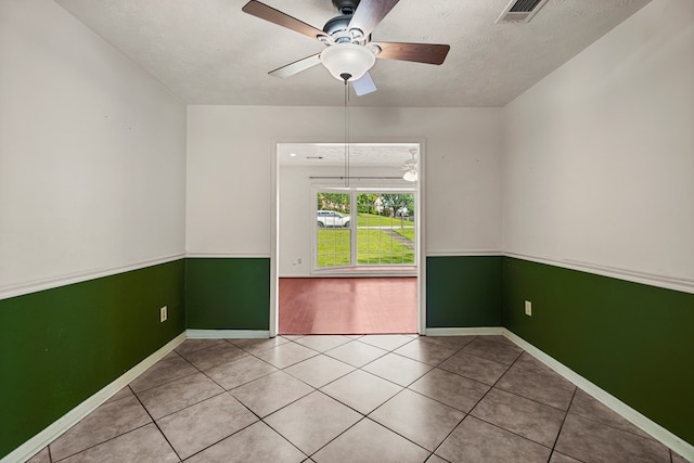 3925 Chris Dr, Columbus, GA 31909 - tiled empty room with a ceiling fan, baseboards, and a textured ceiling