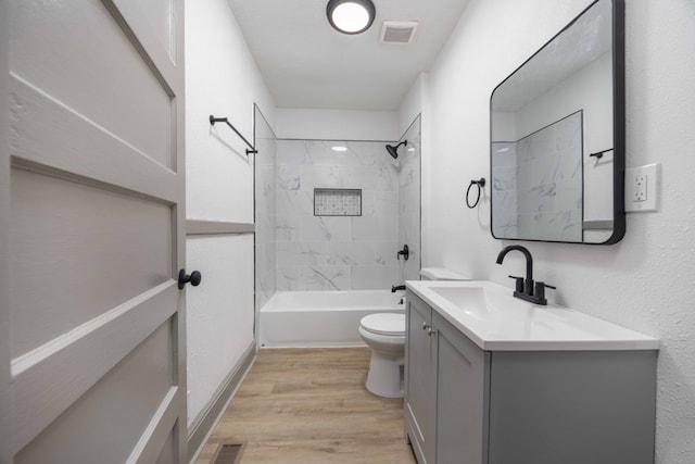 5855 Morningside Dr, Columbus, GA 31909 - bathroom with toilet, vanity, wood finished floors, and shower / washtub combination