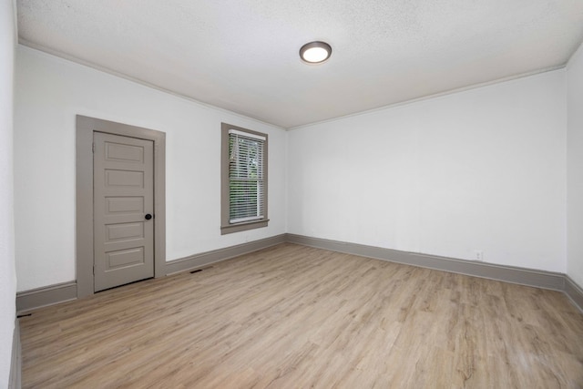 5855 Morningside Dr, Columbus, GA 31909 - empty room with light wood-style floors, baseboards, crown molding, and a textured ceiling