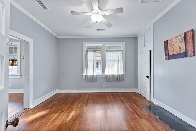 unfurnished room with ceiling fan, dark hardwood / wood-style flooring, and crown molding