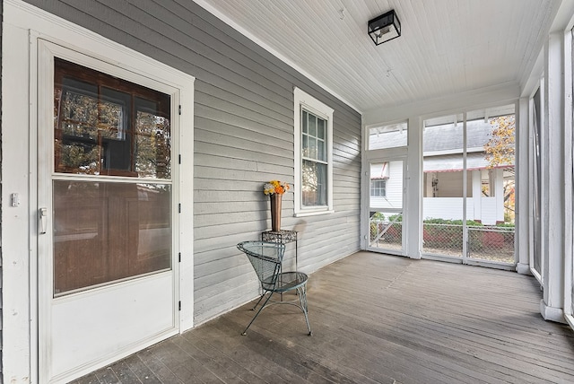 unfurnished sunroom with a wealth of natural light and wooden ceiling