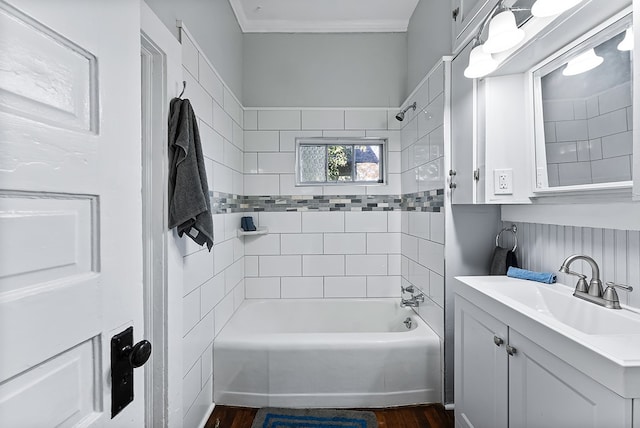 bathroom with vanity, wood-type flooring, tiled shower / bath combo, and ornamental molding