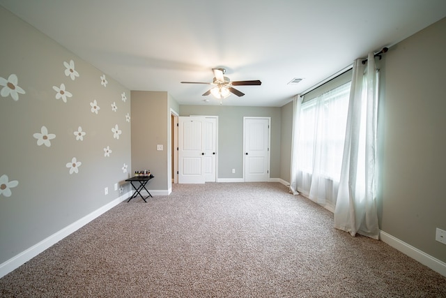 402 Lee Road 2203, Phenix City, AL 36870 - unfurnished bedroom featuring two closets, light colored carpet, and ceiling fan
