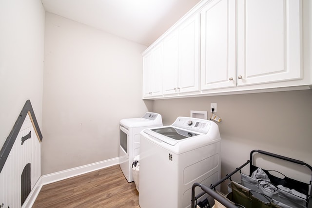 402 Lee Road 2203, Phenix City, AL 36870 - laundry area with cabinet space, washing machine and clothes dryer, and light wood-style floors