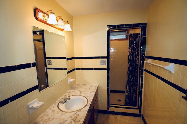 bathroom featuring tile walls, tile patterned flooring, vanity, and walk in shower