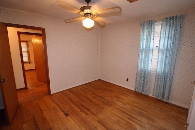 unfurnished bedroom with ceiling fan and wood-type flooring