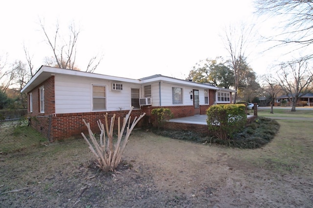 ranch-style house with a patio area and cooling unit