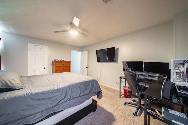 bedroom with a ceiling fan, baseboards, and carpet