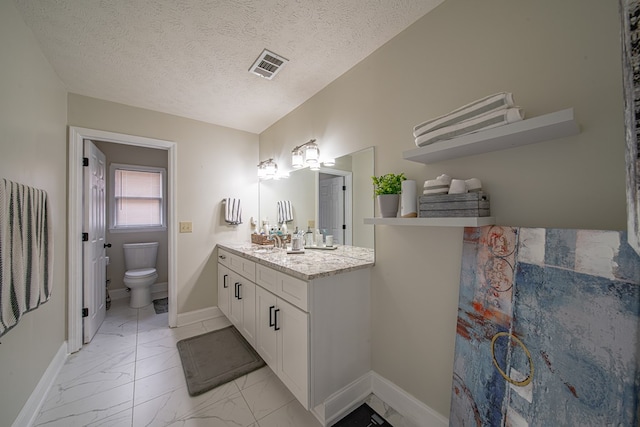 bathroom with vanity, toilet, marble finish floor, baseboards, and visible vents