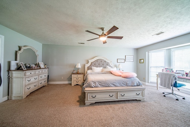 bedroom with visible vents, a textured ceiling, and carpet
