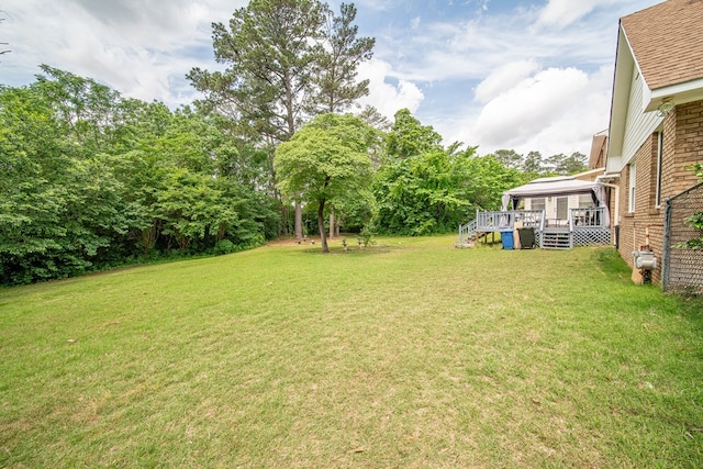view of yard featuring a wooden deck