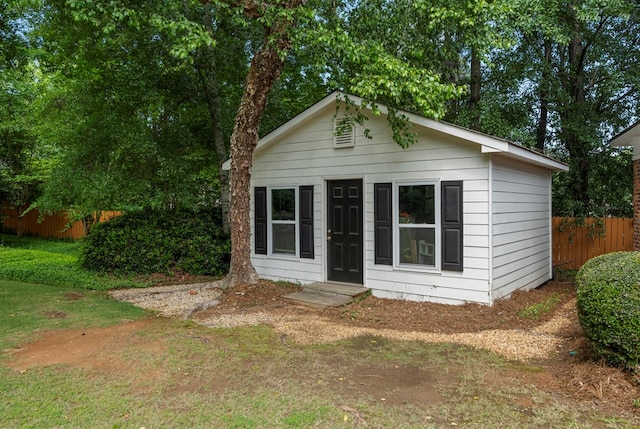 view of outbuilding with fence
