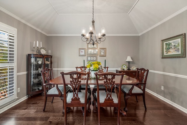 dining space featuring wood finished floors, a chandelier, crown molding, baseboards, and lofted ceiling