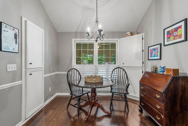 dining space featuring a chandelier, vaulted ceiling, dark wood finished floors, and baseboards