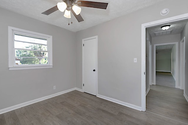 3122 Glenwood Dr, Columbus, GA 31906 - unfurnished bedroom featuring wood finished floors, a textured ceiling, a ceiling fan, and a closet