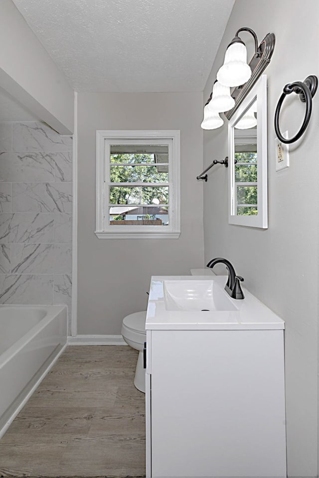 3122 Glenwood Dr, Columbus, GA 31906 - full bath with vanity, a textured ceiling, wood finished floors, and shower / bath combination