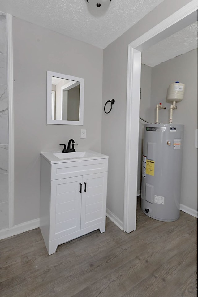 3122 Glenwood Dr, Columbus, GA 31906 - bathroom featuring water heater, vanity, wood finished floors, and a textured ceiling