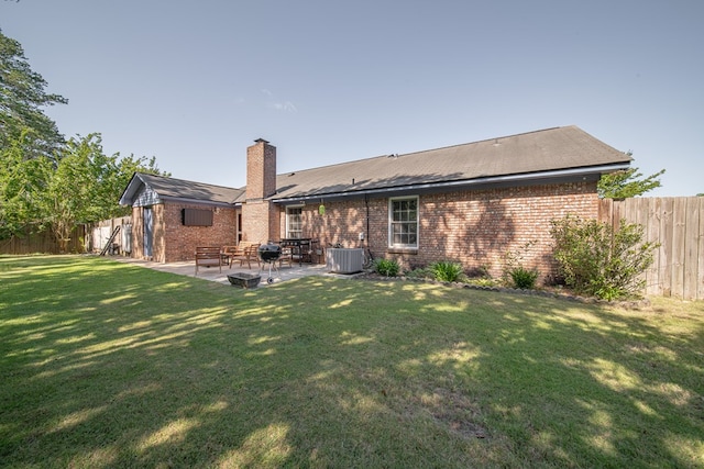 5728 Lexington Dr, Columbus, GA 31907 - back of house with a patio, a fenced backyard, brick siding, and a chimney