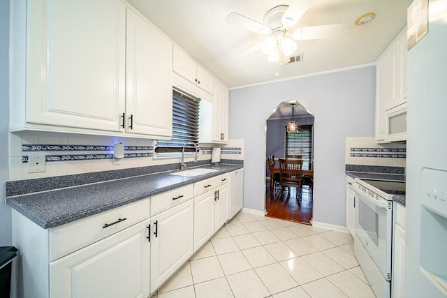 5728 Lexington Dr, Columbus, GA 31907 - kitchen with white appliances, a ceiling fan, backsplash, white cabinets, and light tile patterned floors