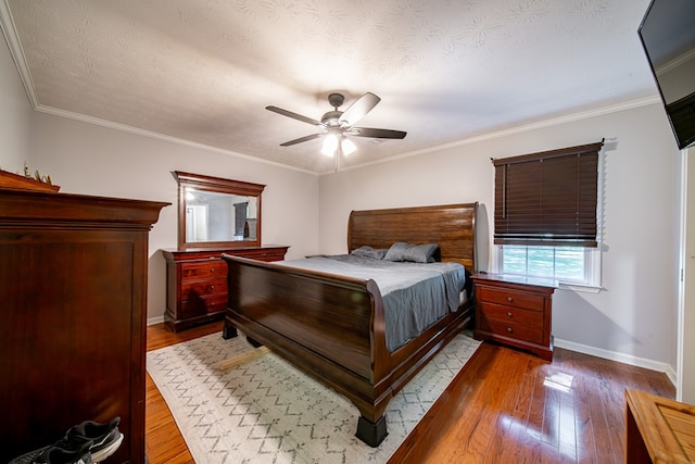 5728 Lexington Dr, Columbus, GA 31907 - bedroom with dark wood-type flooring, a textured ceiling, a ceiling fan, and crown molding
