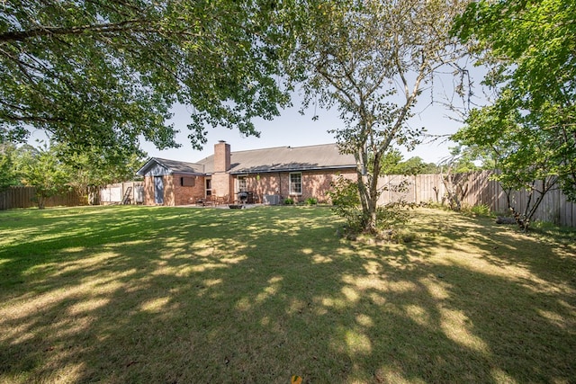 5728 Lexington Dr, Columbus, GA 31907 - back of property featuring a chimney, a fenced backyard, and brick siding