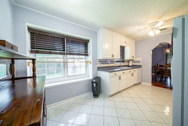 5728 Lexington Dr, Columbus, GA 31907 - kitchen with ceiling fan, dark countertops, ornamental molding, plenty of natural light, and white appliances