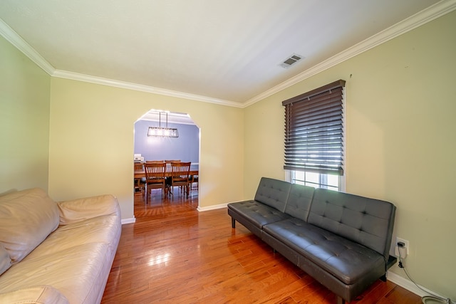 5728 Lexington Dr, Columbus, GA 31907 - living area with arched walkways, crown molding, wood finished floors, and a chandelier