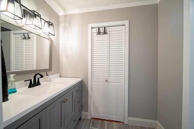 5728 Lexington Dr, Columbus, GA 31907 - bathroom with a closet, vanity, crown molding, and wood finished floors