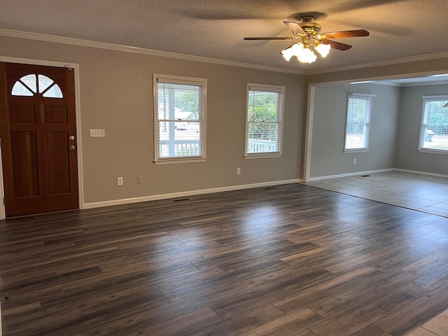 entrance foyer featuring a textured ceiling, crown molding, ceiling fan, and dark wood-type flooring