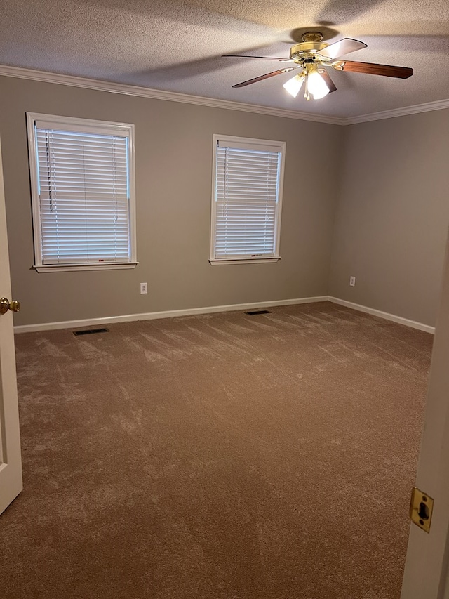 carpeted empty room with a textured ceiling, ceiling fan, and ornamental molding