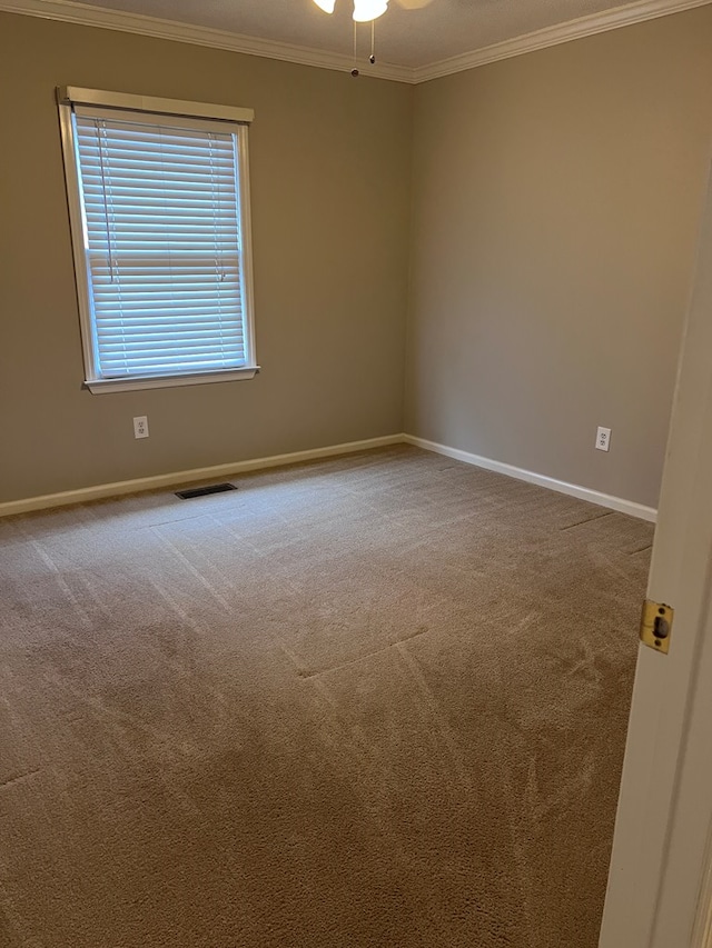 carpeted empty room with crown molding and ceiling fan