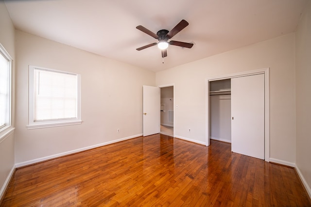 unfurnished bedroom featuring a closet, ceiling fan, and dark wood-type flooring