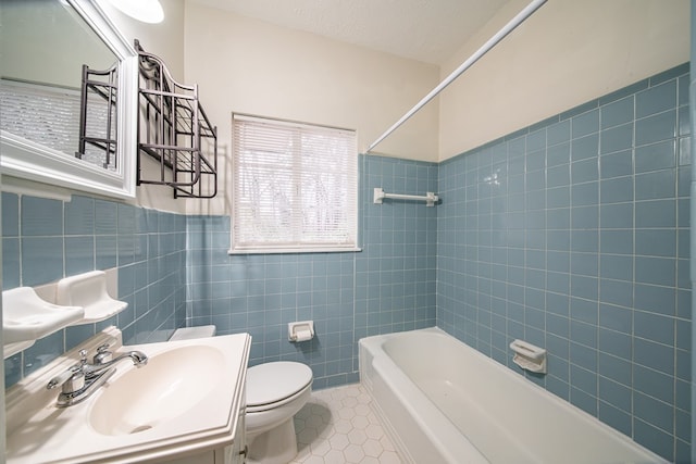 full bathroom featuring tile patterned floors, vanity, tile walls, toilet, and tiled shower / bath