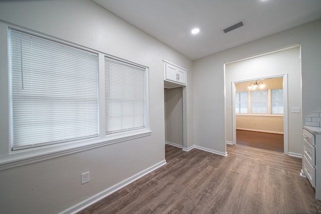 interior space with dark hardwood / wood-style flooring and a notable chandelier