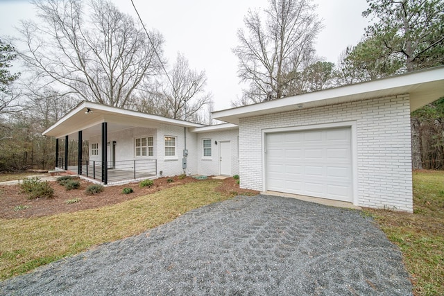 view of front of property with a porch and a garage