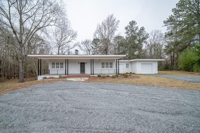 ranch-style house featuring a porch and a garage