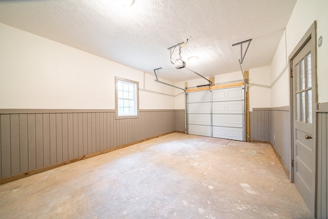 garage featuring wooden walls and a garage door opener