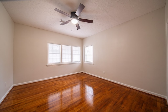 spare room with ceiling fan, hardwood / wood-style floors, and a textured ceiling