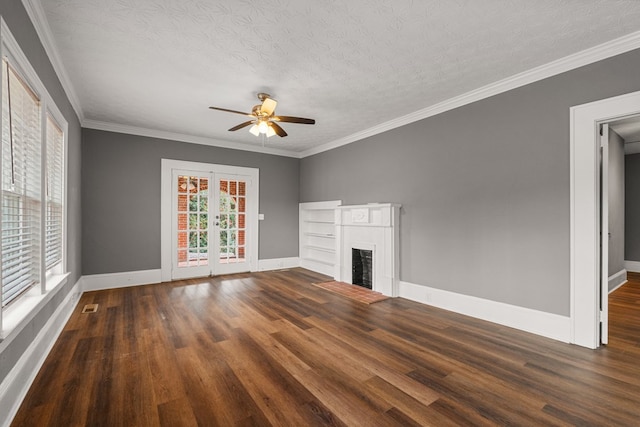 unfurnished living room with a fireplace, a ceiling fan, baseboards, ornamental molding, and dark wood-style floors