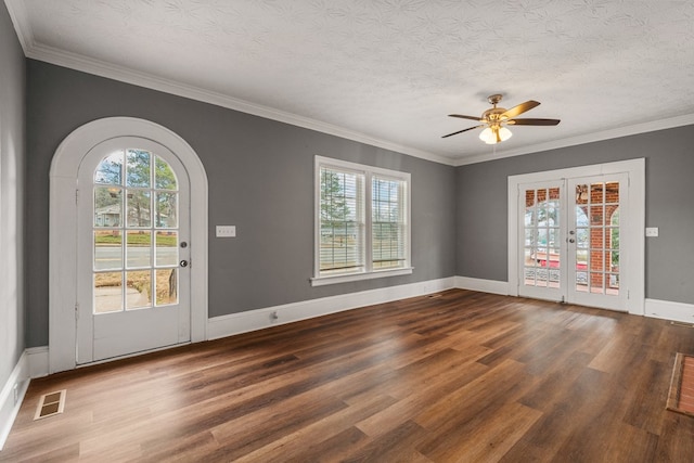 interior space with dark wood-style flooring, visible vents, and a healthy amount of sunlight